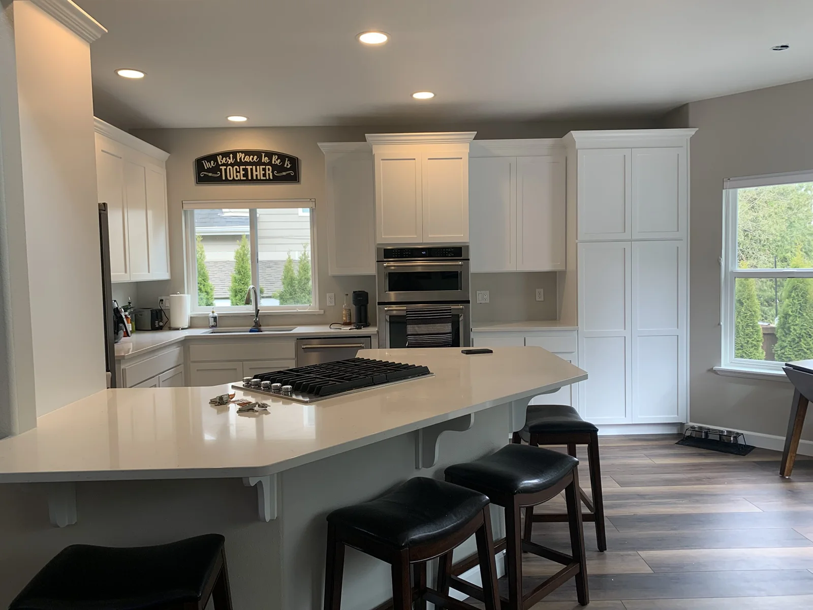 Kitchen painting Everett — newly painted white kitchen with elegant breakfast bar and cabinets.