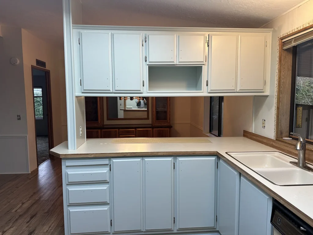 Kitchen cabinets painting in Everett — elegant white cabinets that look brand new after professional painting services.
