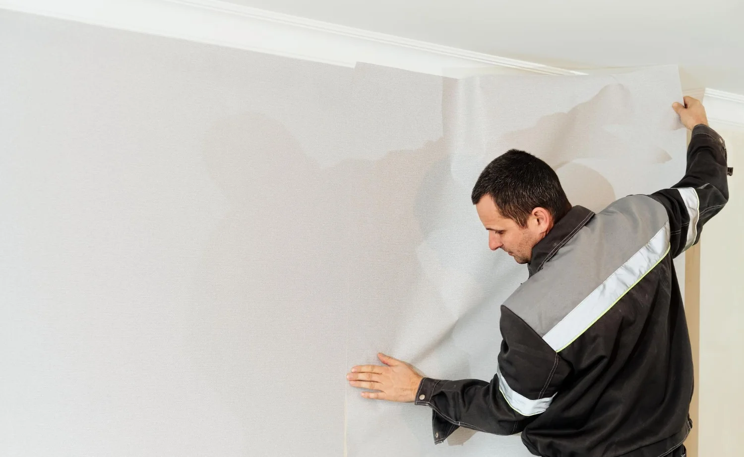 Professional painter doing wallpaper removal Everett WA for wall preparation before painting