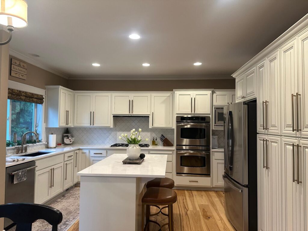 Before and after cabinet painting over replacement highlighting full kitchen transformation.